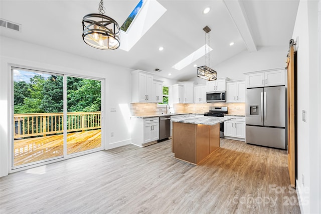 2027 Marquesas Ave, Tega Cay, SC 29708 - kitchen featuring appliances with stainless steel finishes, a skylight, backsplash, plenty of natural light, and recessed lighting