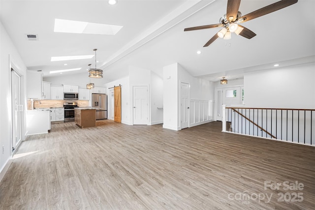 2027 Marquesas Ave, Tega Cay, SC 29708 - unfurnished living room with a skylight, light wood-style flooring, recessed lighting, high vaulted ceiling, and ceiling fan