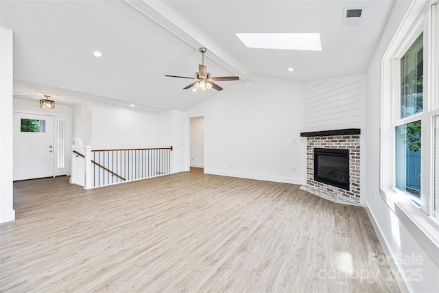 2027 Marquesas Ave, Tega Cay, SC 29708 - unfurnished living room featuring light wood-style floors, a brick fireplace, a skylight, recessed lighting, and a ceiling fan