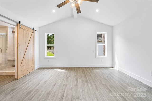 2027 Marquesas Ave, Tega Cay, SC 29708 - unfurnished bedroom featuring light wood finished floors, a barn door, recessed lighting, ensuite bathroom, and a ceiling fan