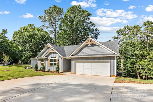 2027 Marquesas Ave, Tega Cay, SC 29708 - view of front of home with board and batten siding, driveway, a garage, and a front yard