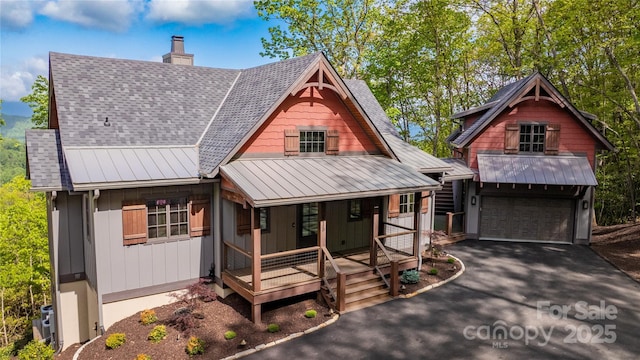 615 Macallan Dr Unit 321, Waynesville, NC 28786 - view of front of property with a chimney, covered porch, board and batten siding, asphalt driveway, and metal roof