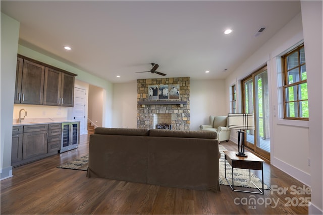615 Macallan Dr Unit 321, Waynesville, NC 28786 - living area with beverage cooler, dark wood-style flooring, a fireplace, ceiling fan, and baseboards