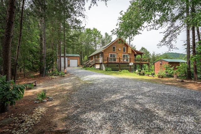 334 Arbra Mountain Way, Bostic, NC 28018 - log home featuring an outdoor structure, log siding, a detached garage, and a deck