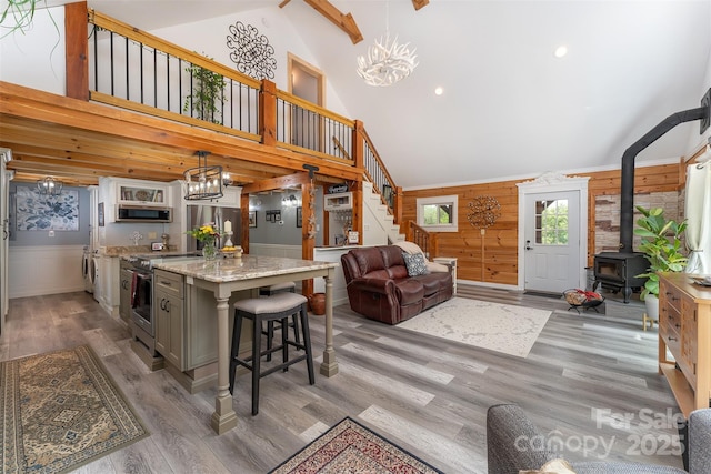 334 Arbra Mountain Way, Bostic, NC 28018 - kitchen with appliances with stainless steel finishes, high vaulted ceiling, open floor plan, wood finished floors, and a chandelier