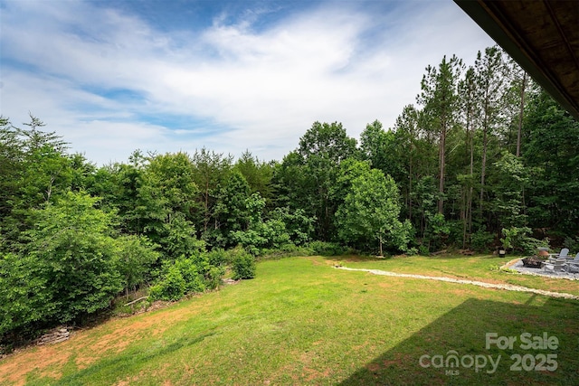 334 Arbra Mountain Way, Bostic, NC 28018 - view of grassy yard featuring a fire pit and a view of trees