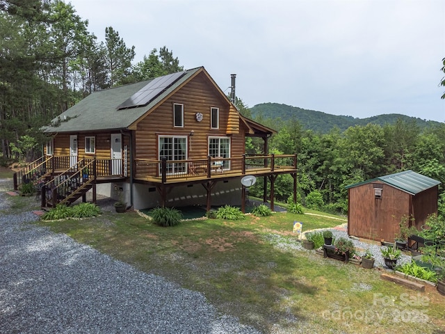 334 Arbra Mountain Way, Bostic, NC 28018 - view of side of home featuring roof mounted solar panels, a yard, a deck with mountain view, and roof with shingles