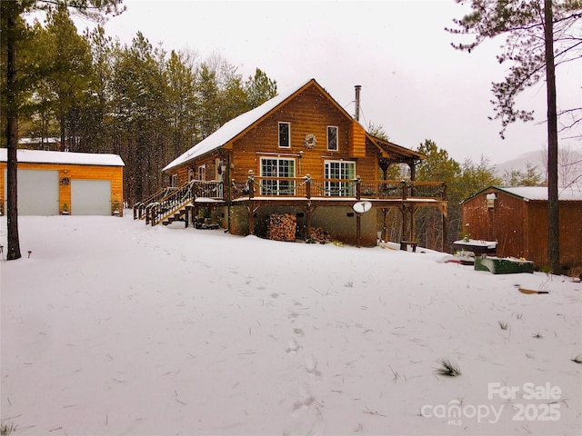 334 Arbra Mountain Way, Bostic, NC 28018 - snow covered rear of property with an outdoor structure and a wooden deck
