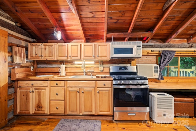 3739 Pickens Hwy, Rosman, NC 28772 - kitchen with white microwave, stainless steel gas stove, wooden ceiling with exposed beams, a sink, and light wood-style floors