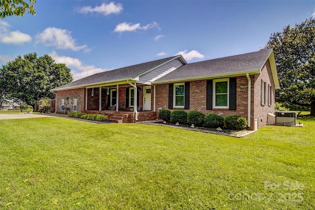 801 Witmore Rd, Wingate, NC 28174 - ranch-style house with a porch, brick siding, and a front yard
