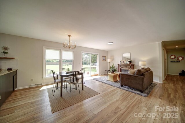 801 Witmore Rd, Wingate, NC 28174 - dining space featuring light wood-type flooring, a chandelier, and baseboards