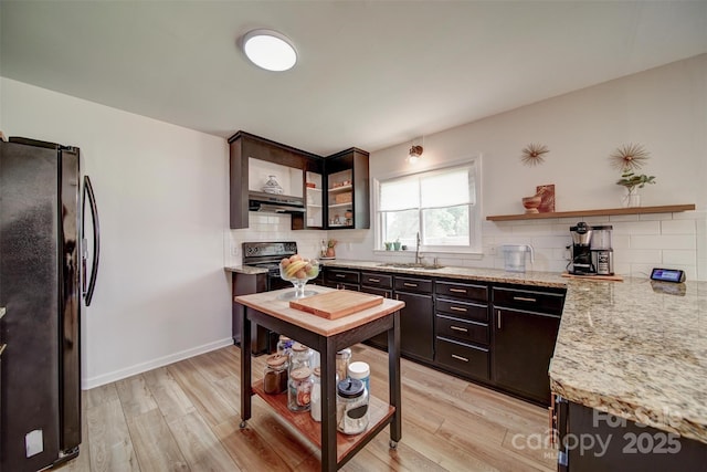 801 Witmore Rd, Wingate, NC 28174 - kitchen featuring black appliances, a sink, under cabinet range hood, tasteful backsplash, and light wood-style flooring