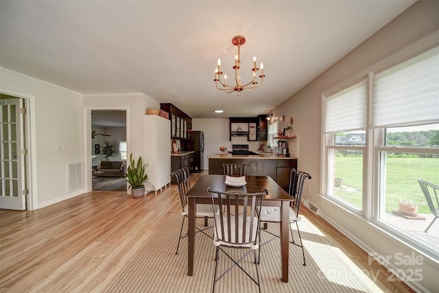 801 Witmore Rd, Wingate, NC 28174 - dining area with light wood-style flooring, a chandelier, and baseboards