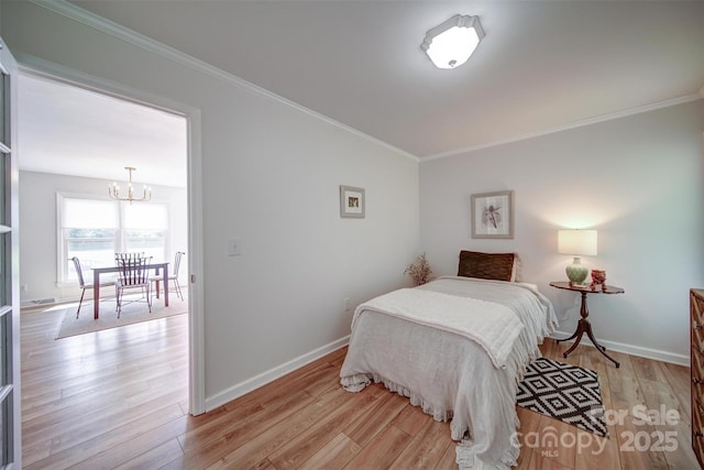 801 Witmore Rd, Wingate, NC 28174 - bedroom featuring a chandelier, light wood-type flooring, crown molding, and baseboards
