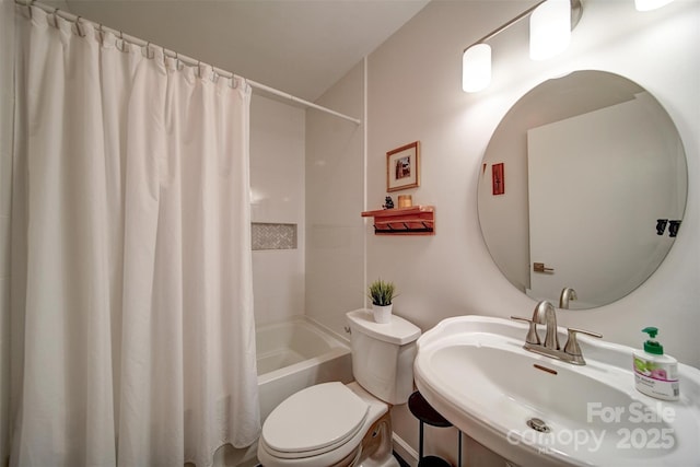 801 Witmore Rd, Wingate, NC 28174 - bathroom featuring toilet, shower / bathtub combination with curtain, and a sink