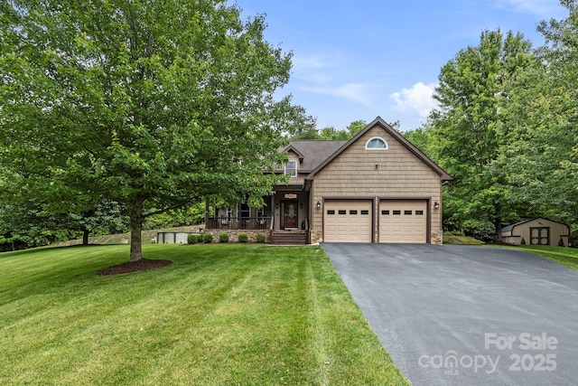 21 School House Rd, Pisgah Forest, NC 28768 - view of front of property with driveway, a storage unit, a garage, a front lawn, and stone siding