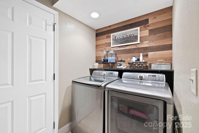 21 School House Rd, Pisgah Forest, NC 28768 - laundry room featuring independent washer and dryer, wood walls, a dry bar, and a textured wall
