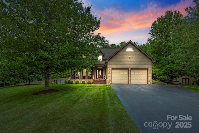 21 School House Rd, Pisgah Forest, NC 28768 - view of front of house with asphalt driveway, a storage shed, a garage, a front lawn, and stone siding