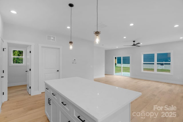 103 Churchill Dr, Kings Mountain, NC 28086 - kitchen featuring light wood-type flooring, white cabinetry, baseboards, a kitchen island, and recessed lighting