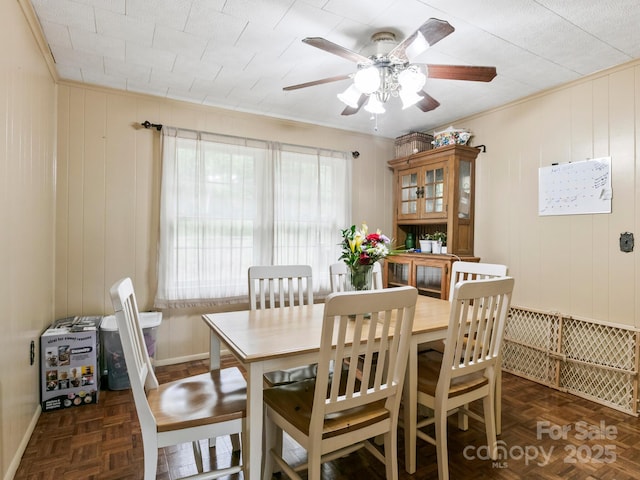86 Hawk Haven Cv, Waynesville, NC 28786 - dining space featuring a ceiling fan, baseboards, ornamental molding, and wood walls
