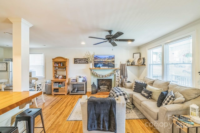 432 4th Street Pl SW, Hickory, NC 28602 - living area with healthy amount of natural light, a ceiling fan, crown molding, light wood-style floors, and a fireplace