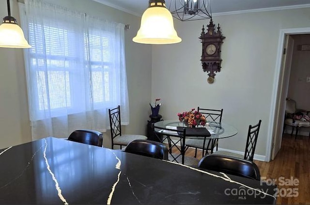 915 Wilkinsville Hwy, Gaffney, SC 29340 - dining room featuring wood finished floors, crown molding, baseboards, and a chandelier