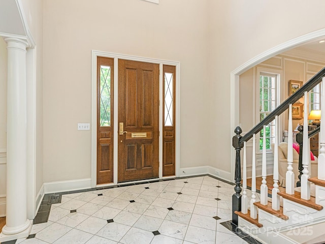 2516 Selwyn Ave, Charlotte, NC 28209 - entrance foyer with baseboards, a towering ceiling, arched walkways, tile patterned floors, and stairway