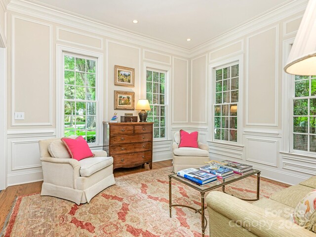 2516 Selwyn Ave, Charlotte, NC 28209 - living area featuring a decorative wall, crown molding, and wood finished floors