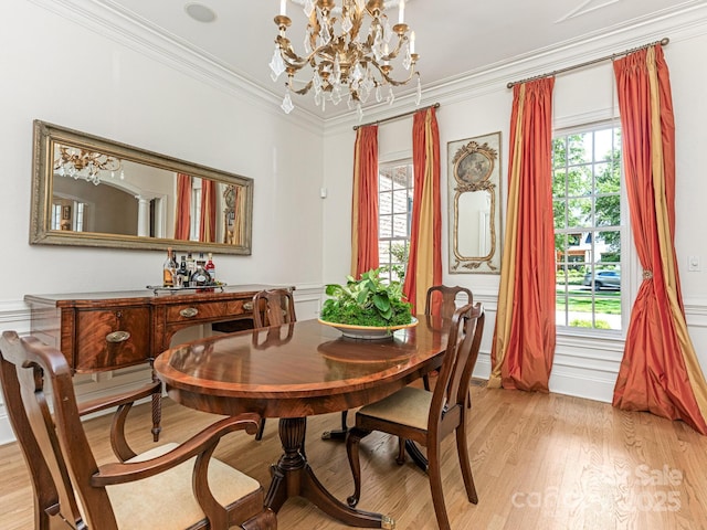 2516 Selwyn Ave, Charlotte, NC 28209 - dining space featuring a chandelier, light wood finished floors, and crown molding