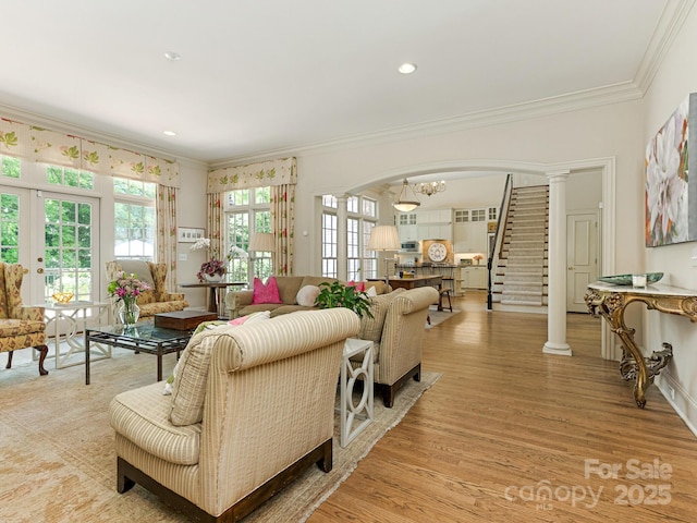 2516 Selwyn Ave, Charlotte, NC 28209 - living room featuring crown molding, light wood finished floors, french doors, arched walkways, and stairs
