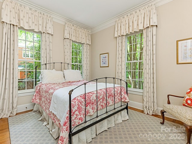2516 Selwyn Ave, Charlotte, NC 28209 - bedroom with crown molding, baseboards, and wood finished floors