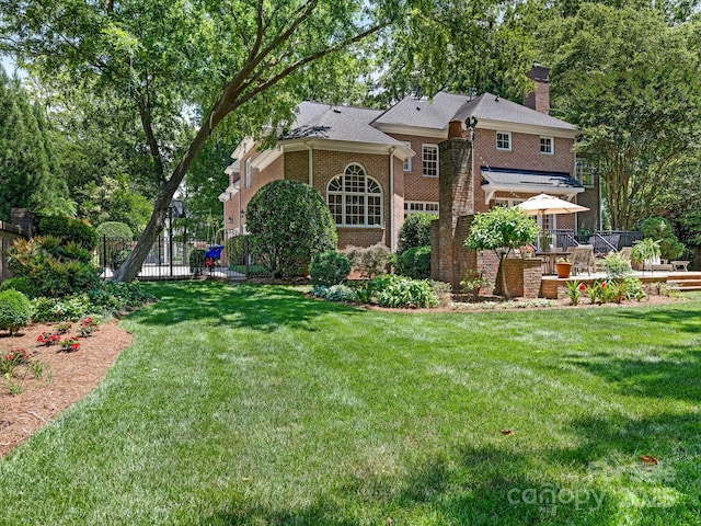 2516 Selwyn Ave, Charlotte, NC 28209 - rear view of property with a chimney, brick siding, and a deck