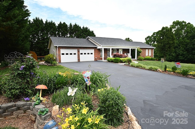 4646 River Run Cir, Hickory, NC 28602 - ranch-style house featuring a garage, asphalt driveway, brick siding, a front yard, and roof with shingles
