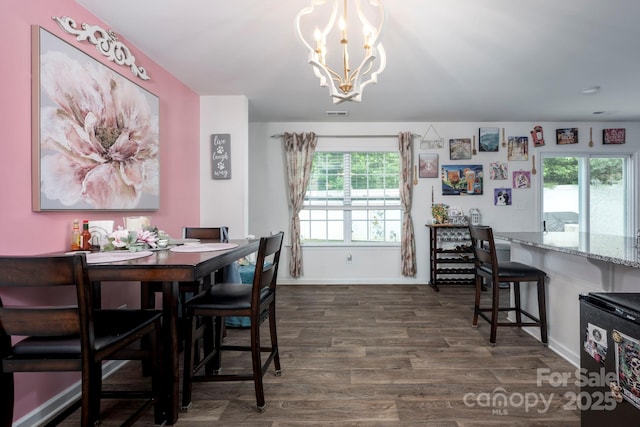7527 Finnigan Rd, Charlotte, NC 28215 - dining room featuring a chandelier, dark wood-style flooring, and baseboards