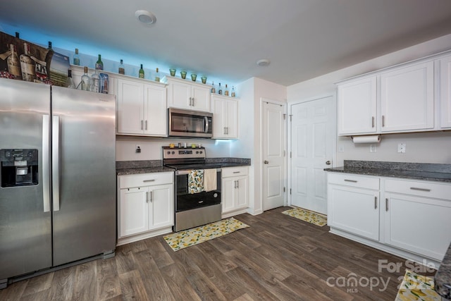 7527 Finnigan Rd, Charlotte, NC 28215 - kitchen with stainless steel appliances, dark wood-style floors, white cabinets, and dark stone countertops