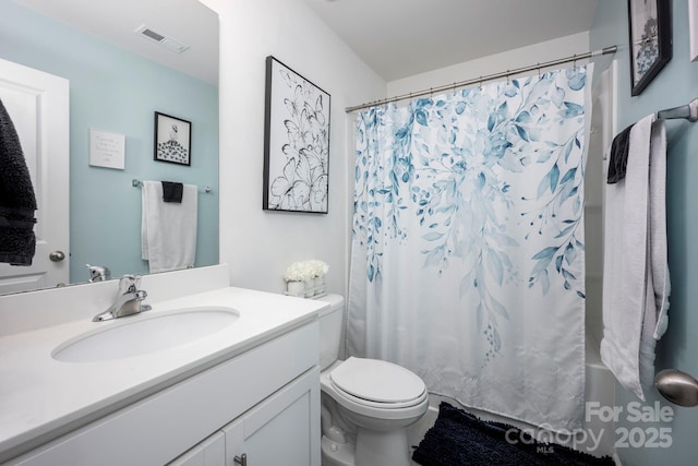 7527 Finnigan Rd, Charlotte, NC 28215 - bathroom featuring vanity, toilet, and shower / tub combo with curtain