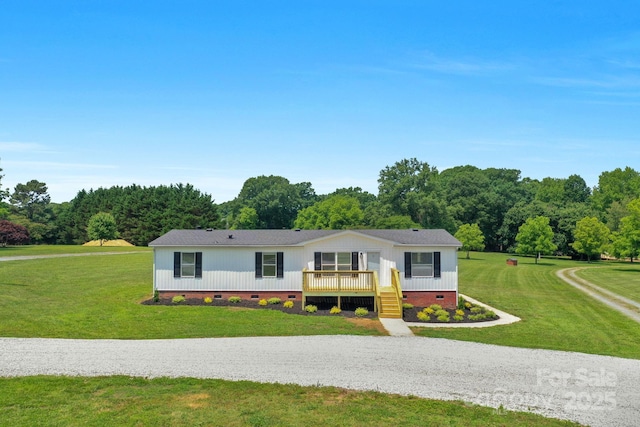 5606 S Rocky River Rd, Monroe, NC 28112 - manufactured / mobile home featuring crawl space, a front yard, roof with shingles, and gravel driveway
