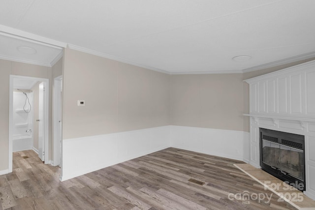 5606 S Rocky River Rd, Monroe, NC 28112 - unfurnished living room featuring a fireplace, wood finished floors, ornamental molding, and wainscoting