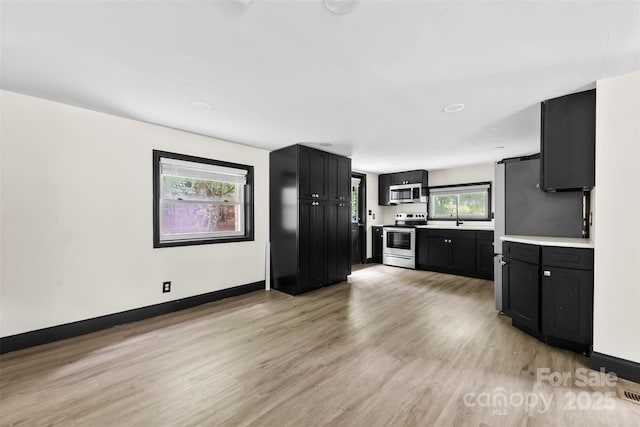 103 Fleetwood Rd, York, SC 29745 - kitchen with appliances with stainless steel finishes, light wood-style floors, light countertops, and dark cabinetry