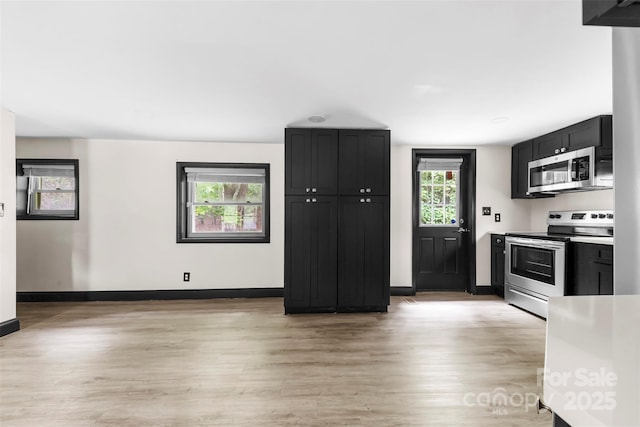 103 Fleetwood Rd, York, SC 29745 - kitchen with appliances with stainless steel finishes, light wood finished floors, baseboards, and dark cabinets
