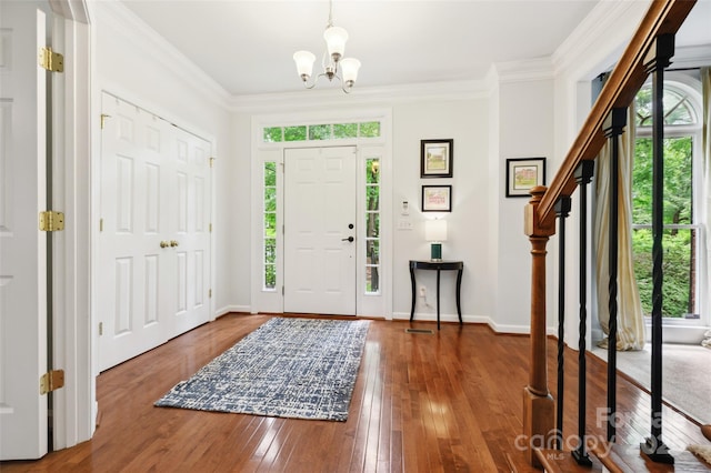8217 Lansford Rd, Charlotte, NC 28277 - foyer featuring healthy amount of natural light, a chandelier, hardwood / wood-style flooring, and crown molding