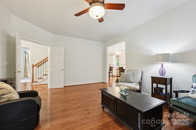 8217 Lansford Rd, Charlotte, NC 28277 - living room featuring ceiling fan, stairs, and light wood-style flooring