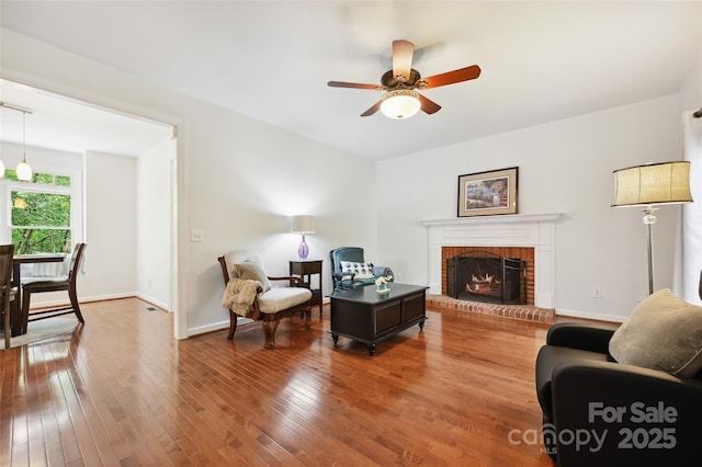 8217 Lansford Rd, Charlotte, NC 28277 - living room featuring a ceiling fan, a brick fireplace, and hardwood / wood-style flooring