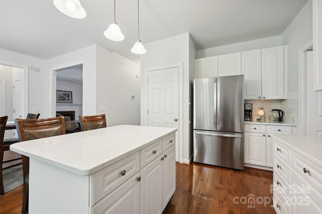 8217 Lansford Rd, Charlotte, NC 28277 - kitchen with freestanding refrigerator, decorative backsplash, and white cabinetry
