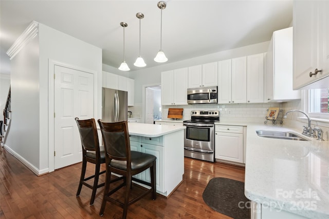 8217 Lansford Rd, Charlotte, NC 28277 - kitchen with appliances with stainless steel finishes, a center island, tasteful backsplash, dark wood-type flooring, and a kitchen breakfast bar