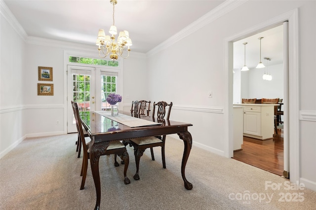8217 Lansford Rd, Charlotte, NC 28277 - carpeted dining space with a chandelier, ornamental molding, and french doors