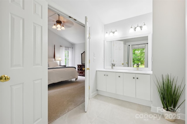 8217 Lansford Rd, Charlotte, NC 28277 - bathroom featuring vanity, connected bathroom, vaulted ceiling, and tile patterned floors