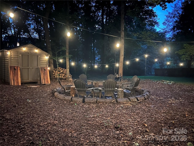 8217 Lansford Rd, Charlotte, NC 28277 - yard at night with a storage shed and an outdoor fire pit