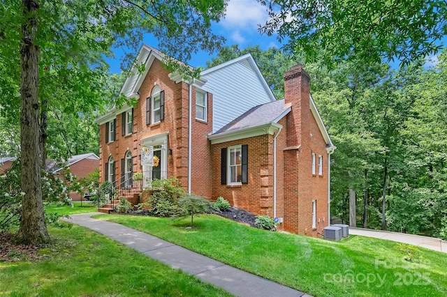 8217 Lansford Rd, Charlotte, NC 28277 - view of front of property with a chimney, a front yard, and brick siding