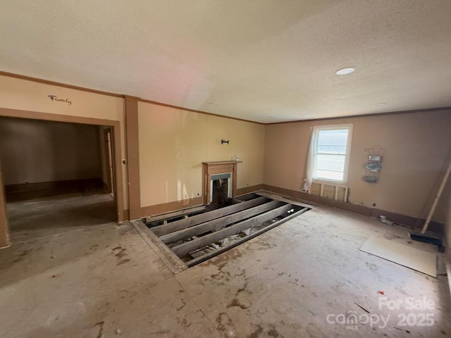 324 S Spruce St, Rock Hill, SC 29730 - unfurnished living room with a textured ceiling, a fireplace, and ornamental molding